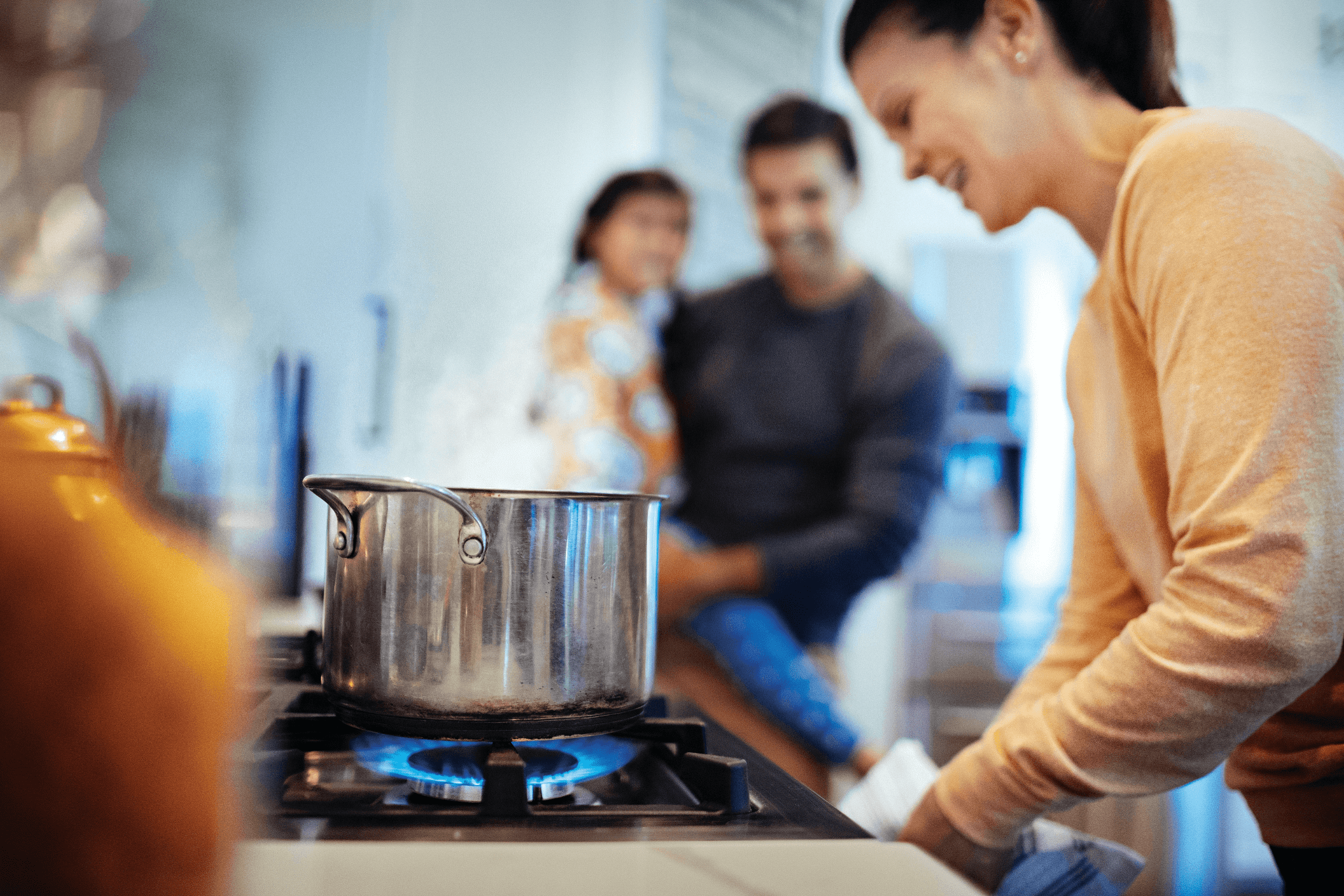 Lady cooking on propane stove
