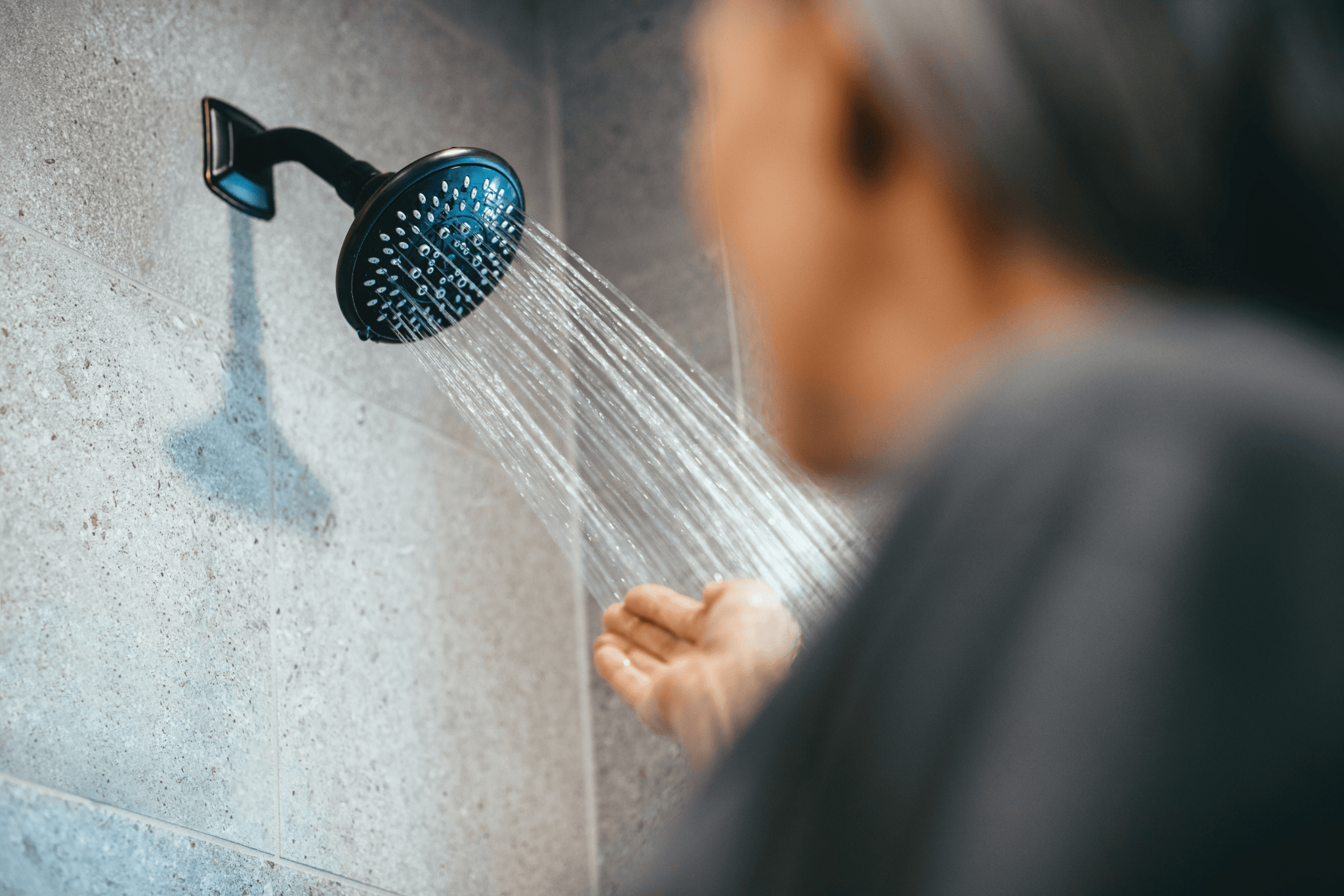 Lady checking shower temperature